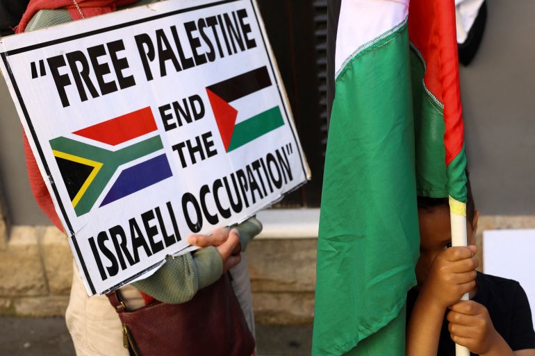 A boy holds a Palestinian flag during a demonstration to express support for the people of Palestine, in Cape Town, South Africa, October 9, 2023. REUTERS/Esa Alexander