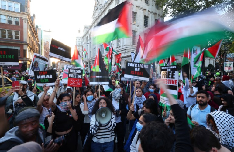 Pro-Palestinian demonstrators protest during the ongoing conflict between Israel and the Palestinian Islamist group Hamas, near the Israeli embassy in London, Britain