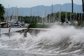 Huge waves crash onto a pier in Puerto Vallarta as Hurricane Lidia nears