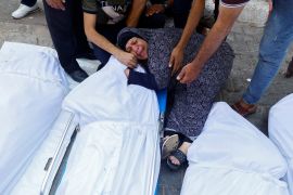 A relative reacts next to the bodies of Palestinians killed in Israeli strikes, at a hospital in Gaza City