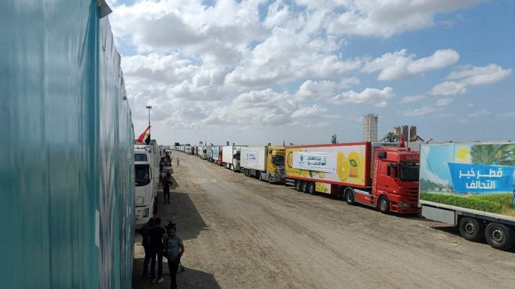 Trucks carrying humanitarian aid from Egyptian NGOs for Palestinians wait for the reopening of the Rafah crossing at the Egyptian side, to enter Gaza