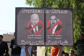 A placard depicting US President Joe Biden and Israeli Prime Minister Benjamin Netanyahu is held during a pro-Palestinian protest in Amman, Jordan on October 18, 2023 [Reuters/Alaa Al Sukhni]