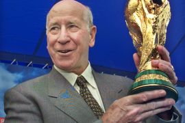 Bobby Charlton holds up the FIFA World Cup trophy