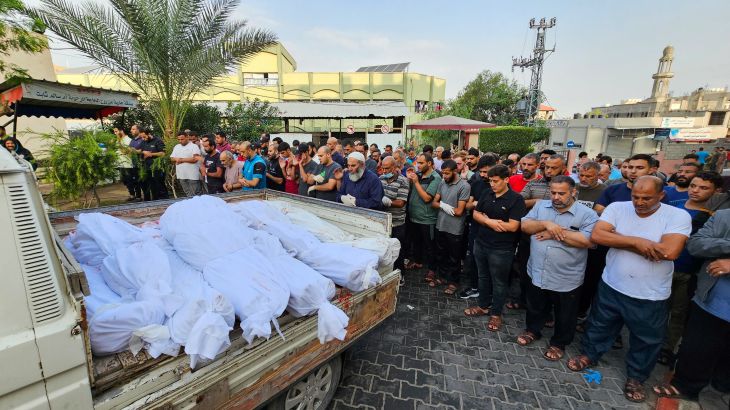 People attend the funeral of Palestinians who were killed in Israeli strikes