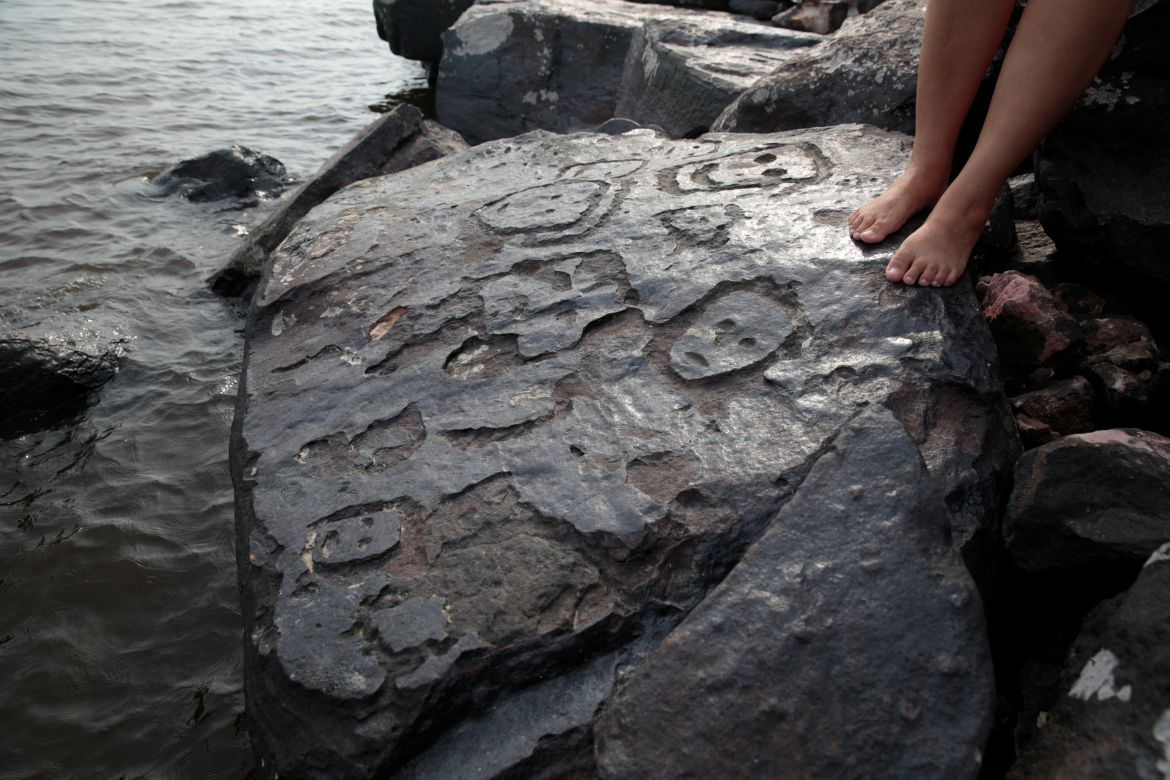 A view of ancient stone carvings on a rocky point of the Amazon river