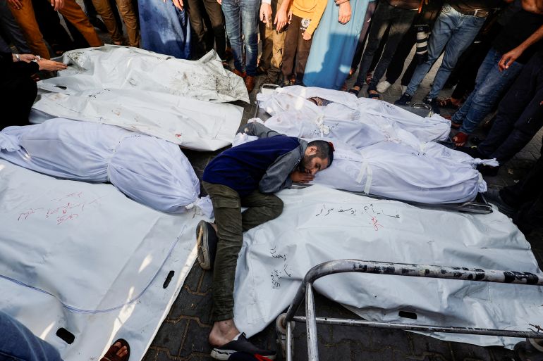 A mourner reacts amidst the bodies as people attend a funeral of Palestinians killed in Israeli strikes
