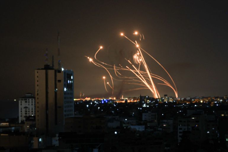 An Israeli missile launched from the Iron Dome defence missile system attempts to intercept a rocket, fired from the Gaza Strip, over the city of Netivot in southern Israel on October 8, 2023.