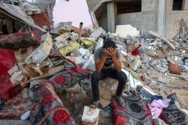 A Palestinian youth reacts as he sits on the rubble of a destroyed home following an Israeli military strike on the Rafah refugee camp, in the southern of Gaza Strip on Octobers 15, 2023, amid the ongoing battles between Israel and the Palestinian Islamist group Hamas. Thousands of people, both Israeli and Palestinians have died since October 7, 2023, after Palestinian Hamas militants based in the Gaza Strip, entered southern Israel in a surprise attack leading Israel to declare war on Hamas in Gaza on October 8. (Photo by MOHAMMED ABED / AFP)