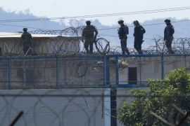 Police walk on top of Litoral Penitentiary amid days of deadly clashes inside the prison, triggered by the transfer of hundreds of inmates in Guayaquil, Ecuador, Friday, Nov. 4, 2022. (AP Photo/Dolores Ochoa)