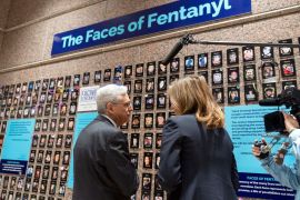 Attorney General Merrick Garland accompanied by U.S. Drug Enforcement Administration Administrator Anne Milgram,​ looks at photographs of people who had died from drugs during the Second Annual Family Summit on Fentanyl at DEA Headquarters in Washington, Tuesday, Sept. 26, 2023. (AP Photo/Jose Luis Magana)