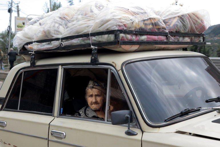An ethnic Armenian woman sits in a car