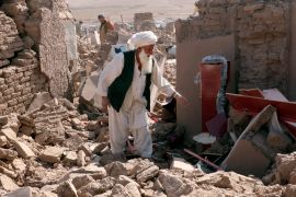 A man cleans up after an earthquake in Zenda Jan district in Herat province, of western Afghanistan