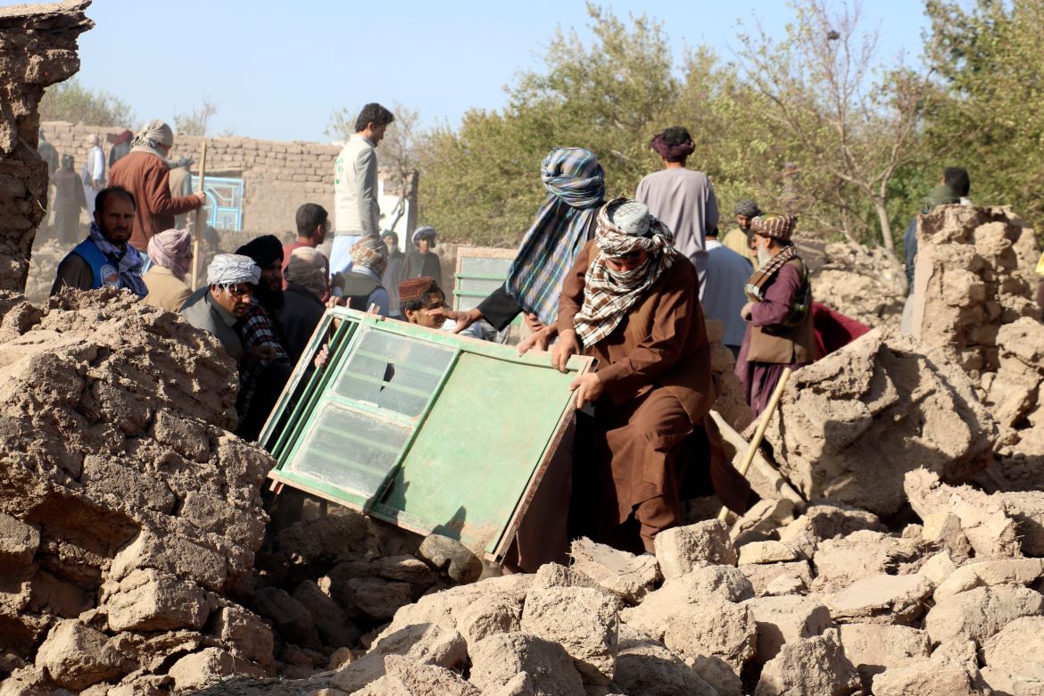 Afghan men remove debris after an earthquake in Zenda Jan district in Herat province, of western Afghanistan