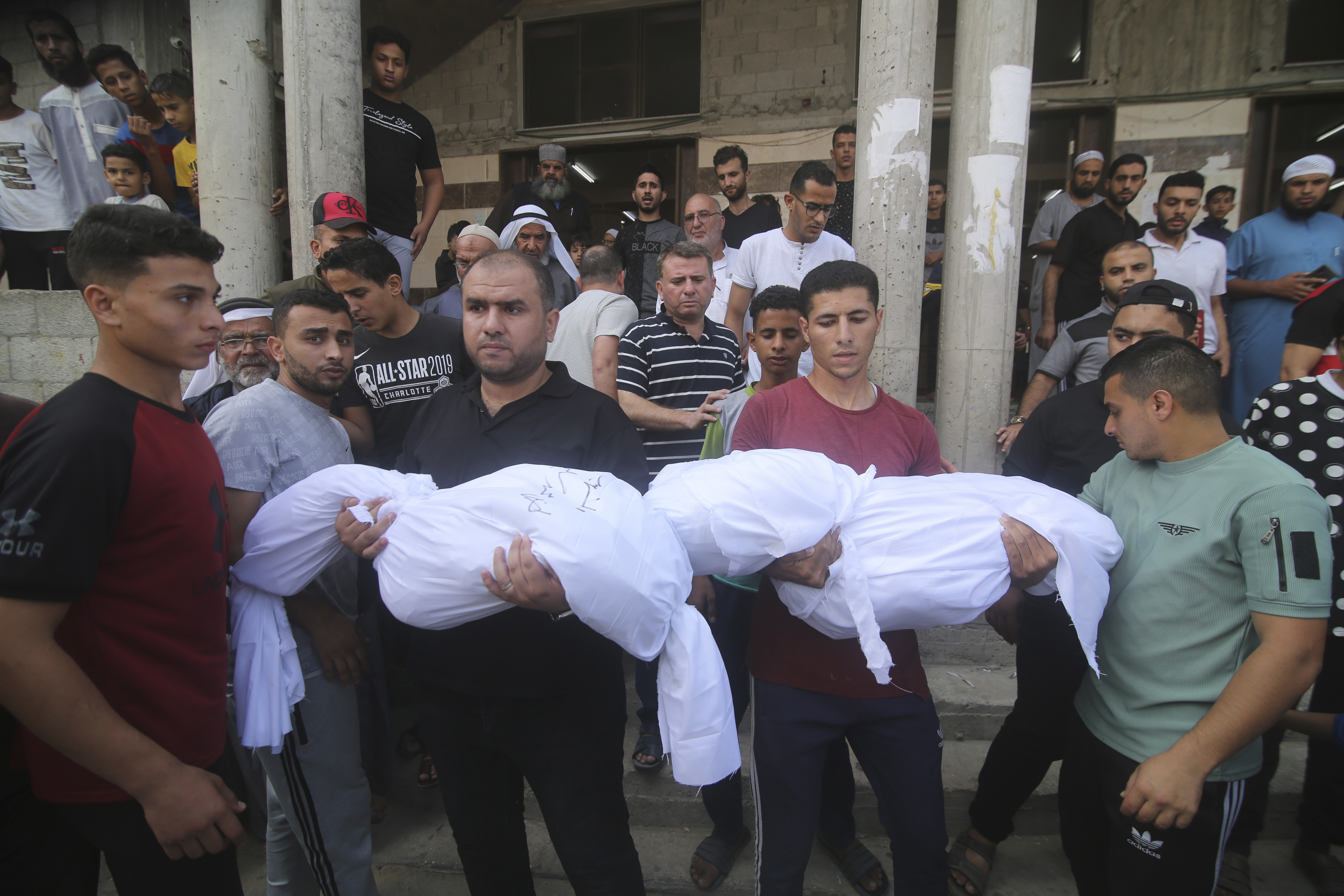 Mourners carry bodies of Salem Abu Quta family members, during a funeral after they were killed in an Israeli strike on their house in Rafah refugee camp, southern Gaza Strip