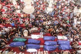 Mourners pray by the bodies of Salem Abu Quta family members, a Hamas fighter, during a funeral after they were killed in an Israeli strike on their house in Rafah refugee camp, southern Gaza Strip