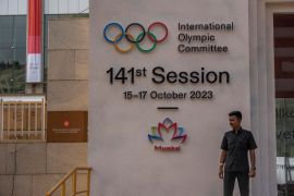 A security guard stands at the entrance of a venue ahead of the upcoming 141st International Olympic Committee (IOC) session in Mumbai, India