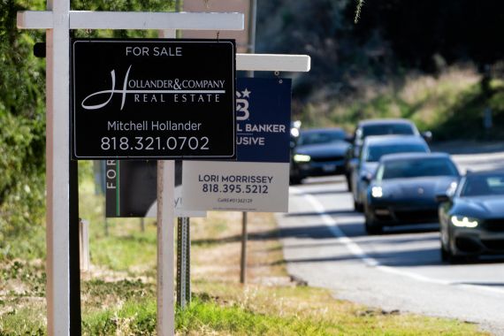 Home sale signs are posted along Topanga Canyon road in Los Angeles, US