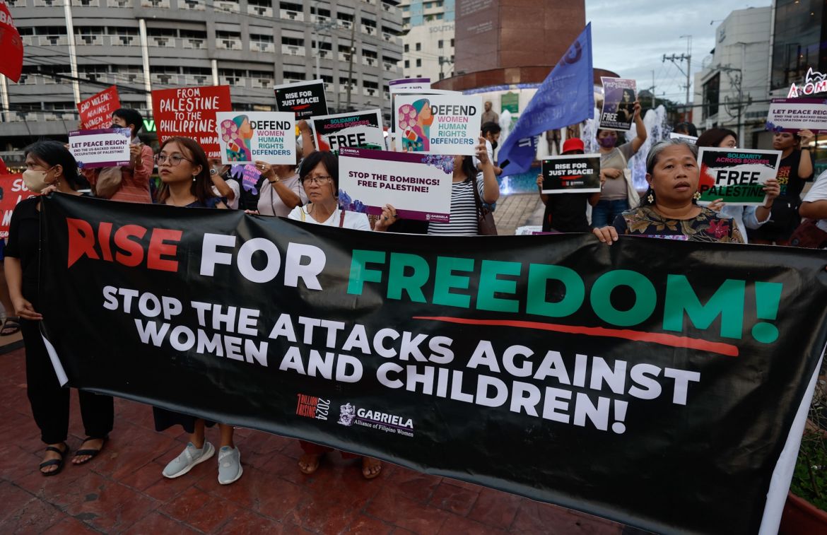 Members of womens rights organizations hold signs supporting Palestine, during a rally in observance of International Day of Solidarity with the Palestinian People, in Quezon City, Metro Manila, Philippines, 29 November 2023.