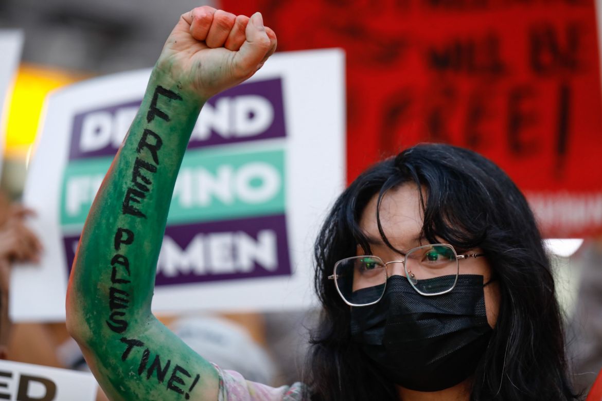 A protester raises her painted arm during a rally in observance of International Day of Solidarity with the Palestinian People, in Quezon City, Metro Manila, Philippines.