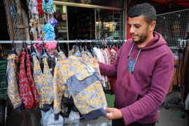 Ali Abulnaja has been selling clothes for seven years in Deir el-Balah [Abdelhakim Abu Riash/Al Jazeera]