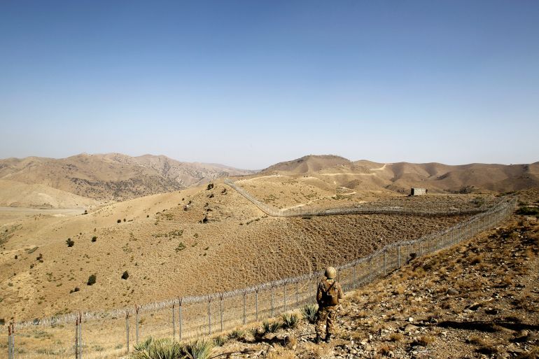 A soldier stands guard along the border fence outside the Kitton outpost on the border with Afghanistan in North Waziristan, Pakistan October 18, 2017. REUTERS/Caren Firouz
