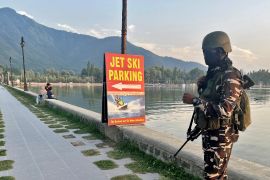 An Indian security officer stands guard on the banks of Dal Lake, one of Kashmir&#039;s main tourist attractions, in Srinagar, on July 6, 2023 [File: Altaf Hussain/Reuters]