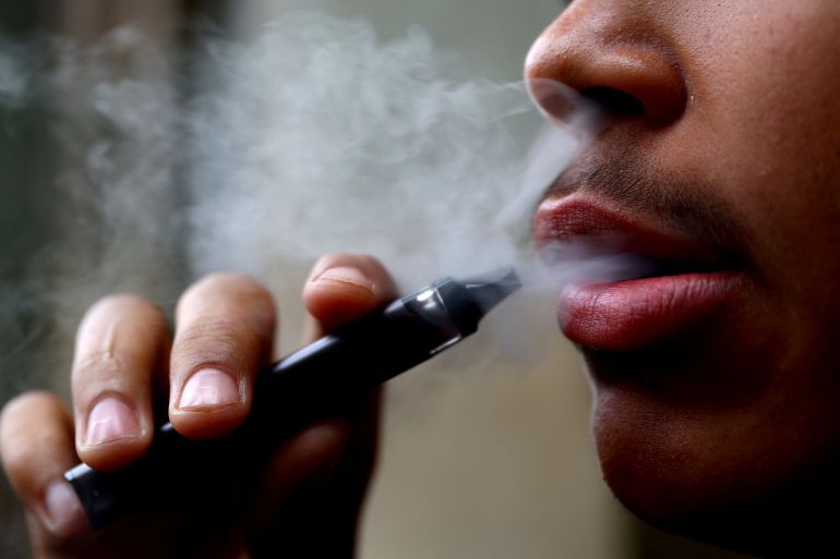 A man smokes a disposable vape, Newcastle-under-Lyme, Britain, September 14, 2023. REUTERS/Carl Recine