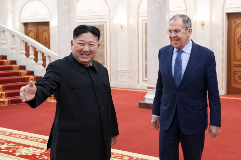 Kim Jong Un with Russian Foreign Minister Sergey Lavrov. They are smiling and laughing.