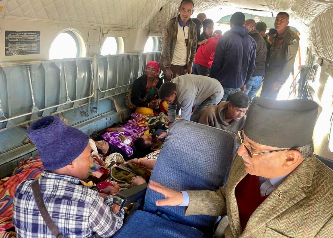 Nepal Prime Minister, Pushpa Kamal Dahal speaks to rescued people inside a helicopter after an earthquake