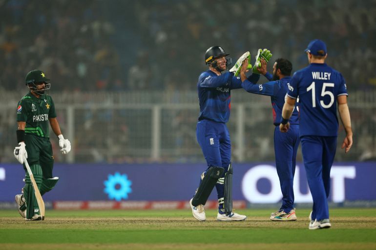 England's Adil Rashid celebrates with Jos Buttler after taking the wicket of Pakistan's Saud Shakeel