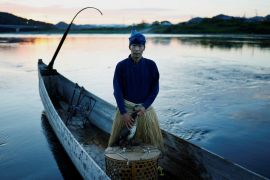 Cormorant fishing master, known as usho, Youichiro Adachi, 48, poses for a picture with his cormorant, before cormorant fishing or ukai, on the Nagara River in Oze, Seki, Japan.