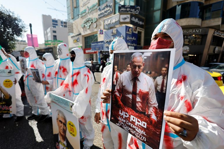Protesters wear shrouds during a protest in solidarity with Gaza and Palestinian prisoners in the Israeli jails in Hebron
