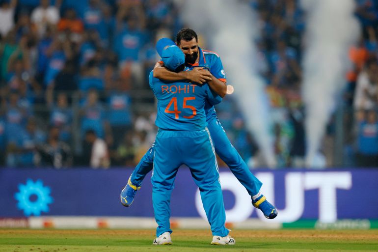 Cricket - ICC Cricket World Cup 2023 - Semi-Final - India v New Zealand - Wankhede Stadium, Mumbai, India - November 15, 2023 India's Mohammed Shami celebrates with Rohit Sharma after taking the wicket of New Zealand's Lockie Ferguson, caught out by KL Rahul to win the match and advance to the finals REUTERS/Adnan Abidi