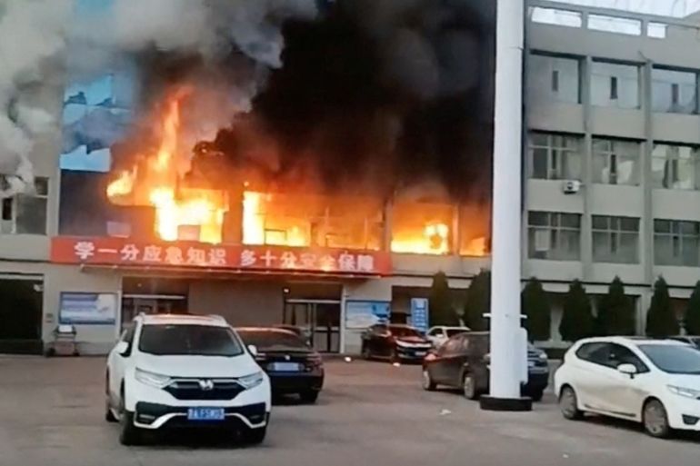 Fire burns at the Yongju Coal Industry Joint Building, in Luliang City