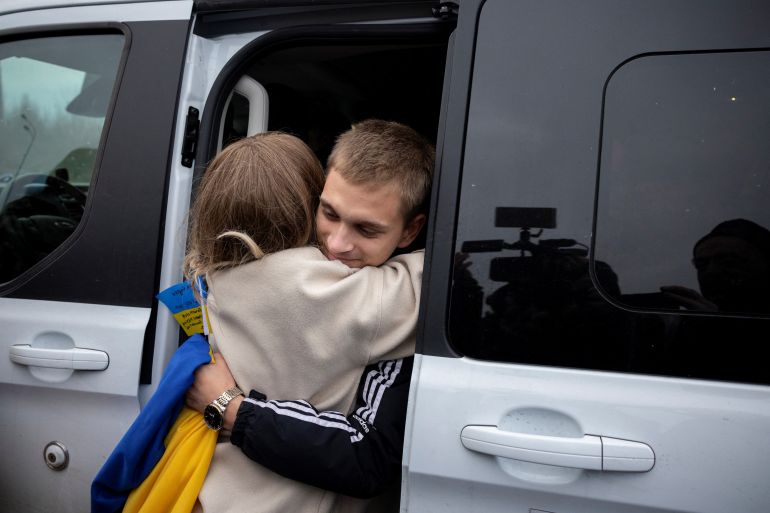 Bohdan Yermokhin, a Ukrainian teenager who was taken to Russia from the occupied city of Mariupol, hugs his lawyer Kateryna Bobrovska after arriving in Ukraine from Belarus at the border crossing in Kortelisy, amid Russia’s ongoing attack on Ukraine, November 19, 2023. REUTERS/Thomas Peter