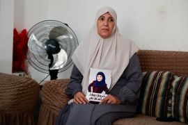 Sameera Dwayyat, the mother of Shorouq Dwayyat, 26, a female Palestinian prisoner serving a 16-year sentence, holds a picture of her daughter,