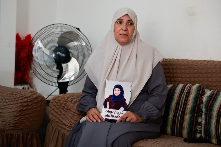 Sameera Dwayyat, the mother of Shorouq Dwayyat, 26, a female Palestinian prisoner serving a 16-year sentence, holds a picture of her daughter.