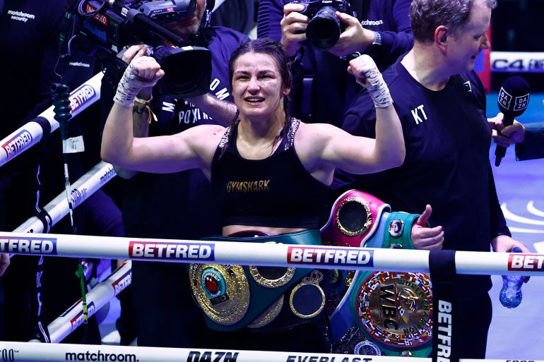 Boxing - Chantelle Cameron v Katie Taylor - IBF, IBO, WBA, WBC & WBO World Super Lightweight Titles - 3Arena, Dublin, Ireland - November 25, 2023 Katie Taylor celebrates with her belts after winning her fight against Chantelle Cameron REUTERS/Clodagh Kilcoyne