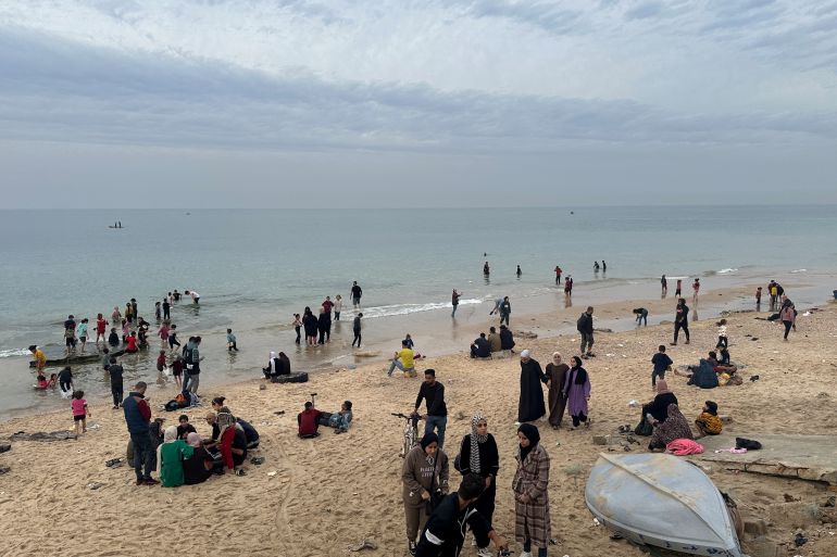 Palestinians spend time on a beach during a temporary truce between Hamas and Israel, in Deir al-Balah in the central Gaza Strip November 25, 2023