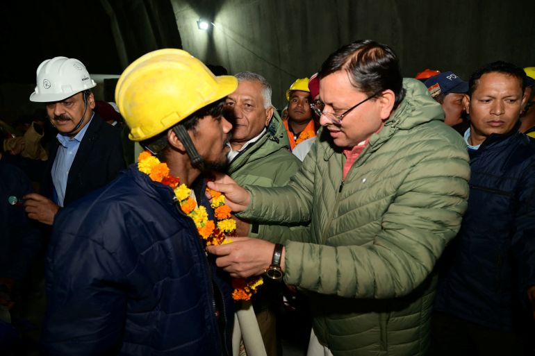 Pushkar Singh Dhami, Chief Minister of the northern state of Uttarakhand, greets a worker after he was rescued from the collapsed tunnel site in Uttarkashi, Uttarakhand, India,