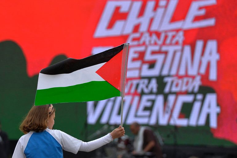 A girl waves a Palestinian flag during "Chile Sings Palestine Against all Violence", a festival with more than 20 national and international artists organized by the Palestinian community of Chile, which aims to support the victims in Gaza, at Padre Hurtado Park in Santiago, on October 25, 2023. - Thousands of civilians, both Palestinians and Israelis, have died since October 7, 2023, after Palestinian Hamas militants based in the Gaza Strip entered southern Israel in an unprecedented attack triggering a war declared by Israel on Hamas with retaliatory bombings on Gaza. (Photo by Guillermo SALGADO / AFP)