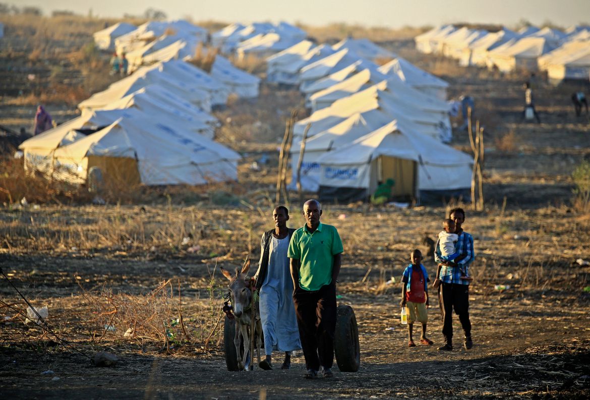 Ethiopian refugees walk together early in the morning on Coptic Christmas day at Um Raquba refugee camp in Gedaref, eastern Sudan.