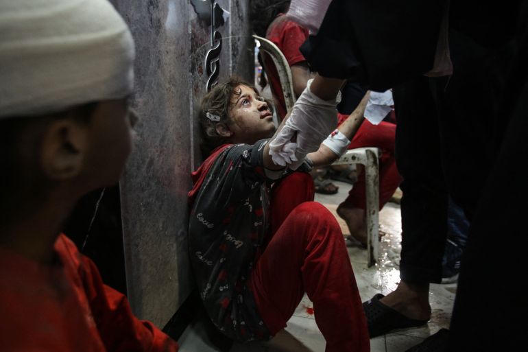 A young injured girl awaits treatment at the emergency ward of the Al-Shifa hospital following an Israeli strike, in Gaza City on November 5, 2023. [Bashar TALEB / AFP)