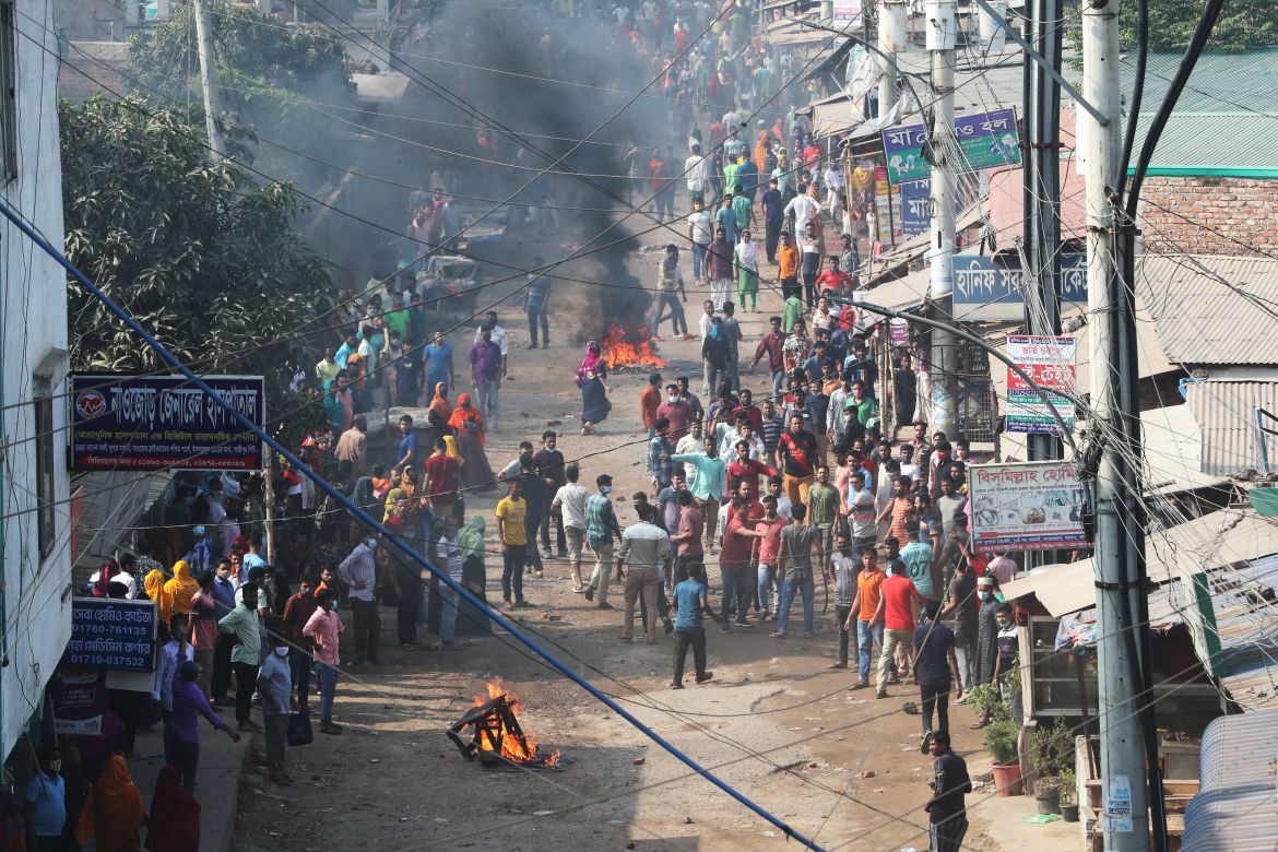 Garment workers gather along a road during a protest in Gazipur on November 9, 2023, after the Minimum Wage Board authority declared the minimum wage of 12,500 taka ($113) for garment workers.