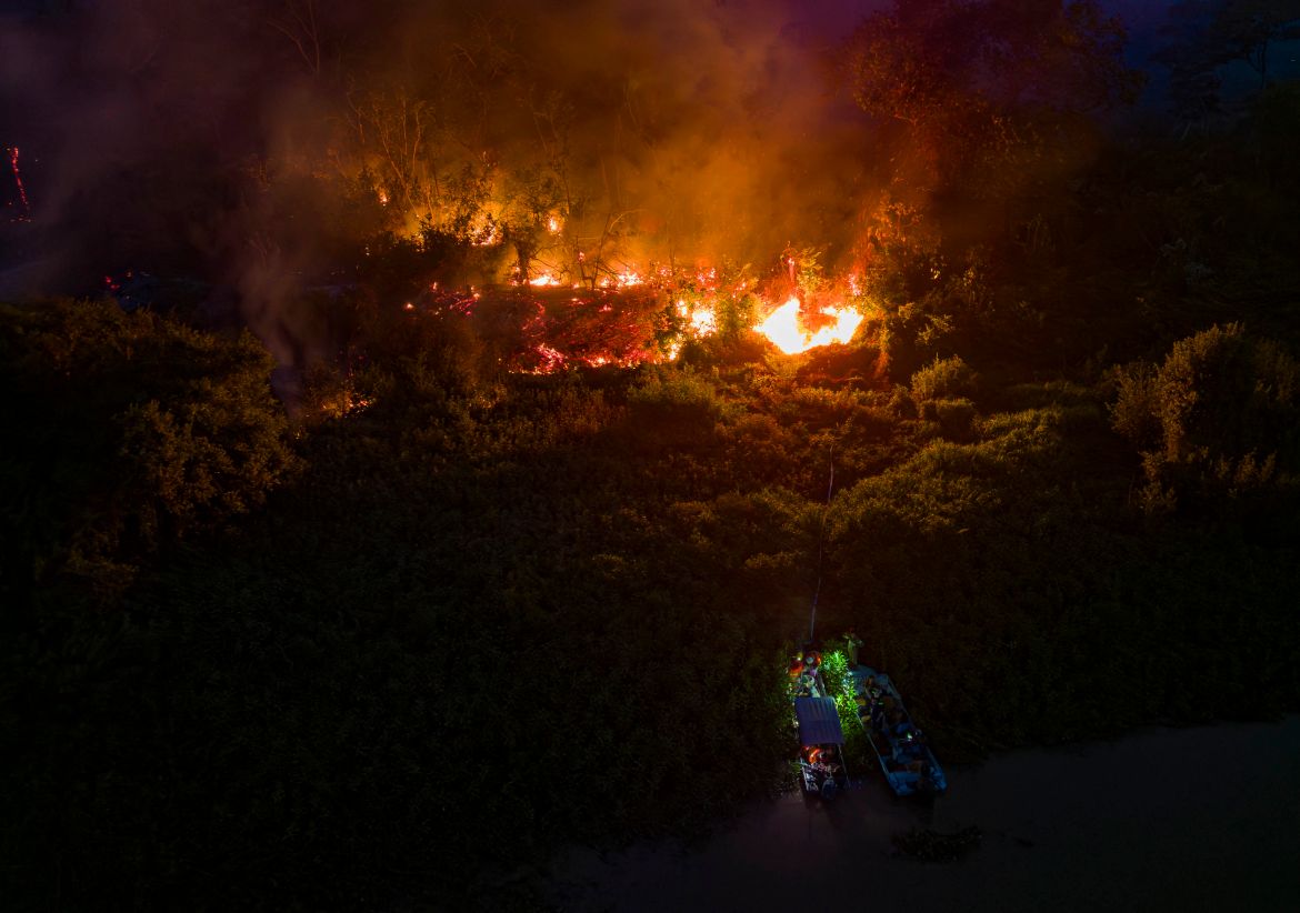 Aerial view showing a forest fire raging at the Encontro das Aguas Park by the Sao Lourenco River in the Pantanal wetland, near Pocone, Mato Grosso State, Brazil.