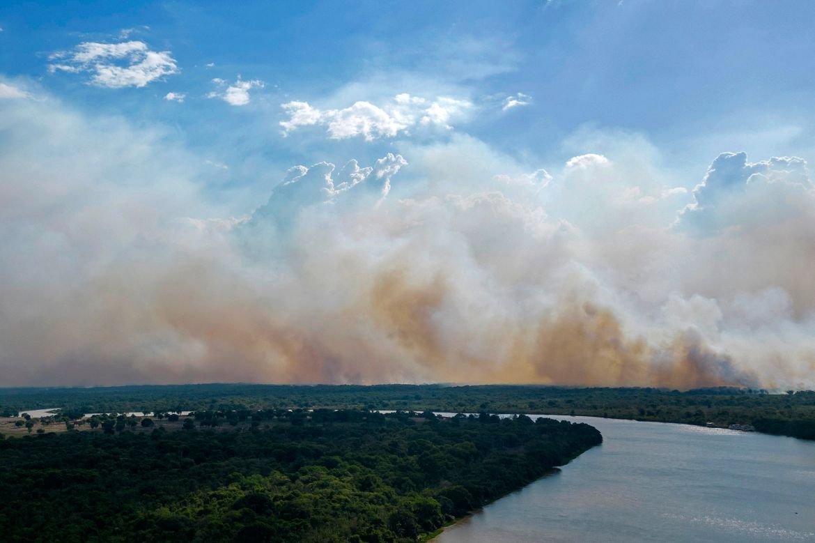 Aerial view showing smoke billowing from forest fires in the Pantanal wetland in Porto Jofre, Mato Grosso State, Brazil.