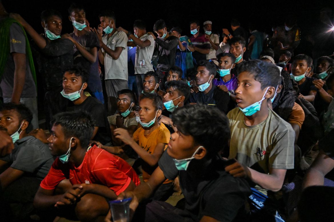 Newly-arrived Rohingya refugees wait to be transferred to a shelter in Batee beach, Aceh province, Indonesia.