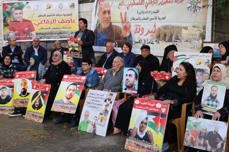 Relatives and supporters of Palestinians held in Israeli prisons stage a sit-in in front of the Red Cross in the West Bank city of Ramallah on November 21, 2023, calling for a deal to be brokered between Israel and Hamas for their release.