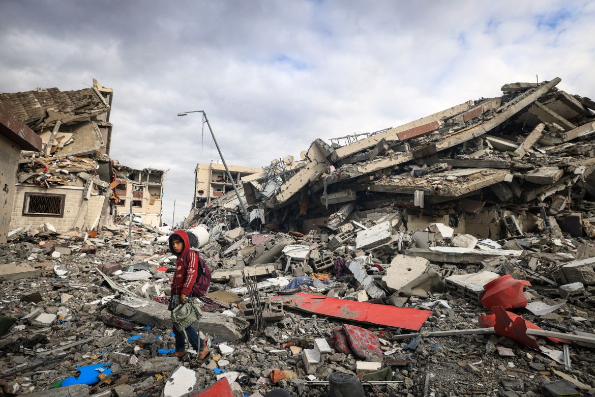 Palestinians inspect the destruction caused by Israeli strikes in Wadi Gaza, in the central Gaza Strip.