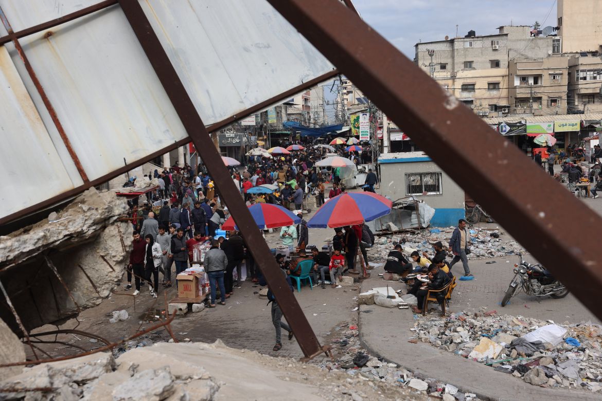 People shop from street vendors amid the destruction in the centre of the southern Gaza Strip city of Khan Yunis.